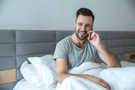 Bachelor man daily routine single lifestyle morning concept phone callの写真素材