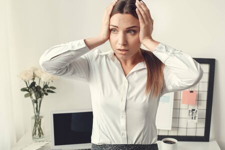 Young woman freelancer indoors home office concept formal style concernedの写真素材