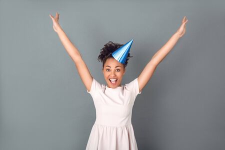Young african woman isolated on grey wall studio celebration concept jumpingの写真素材