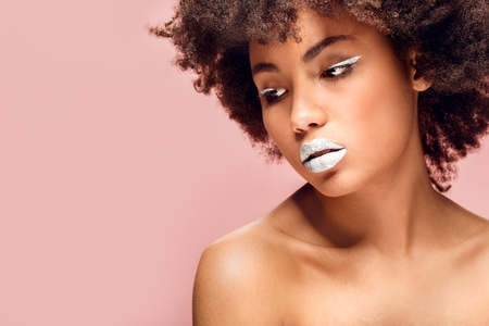 Young african woman isolated on pink wall studio fashion stylish makeup concernedの写真素材