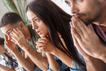Group of friends sport fans watching soccer match hope close-upの写真素材