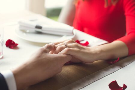 Young couple having romantic dinner in the restaurant wearing a proposal ring romanticの写真素材