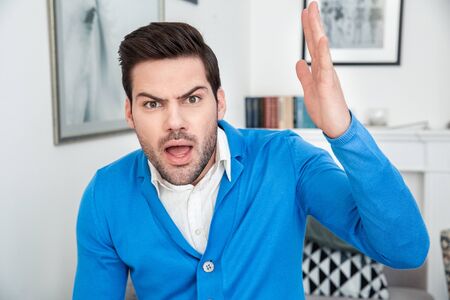 Young man patient waiting psychology session aggresiveの写真素材