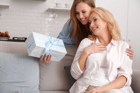Mother and daughter together at home weekend surprise giftの写真素材