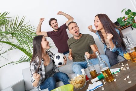 Group of friends sport fans watching match shouting happyの写真素材