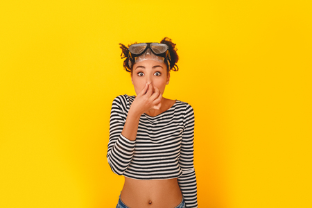 Young african woman isolated on yellow wall studio teen style diving preparationの写真素材