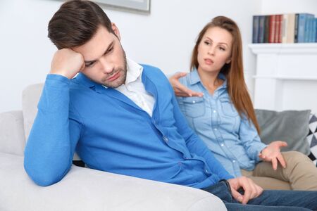 Young couple waiting for psychology session family problems guy turn asude from girlfriendの写真素材