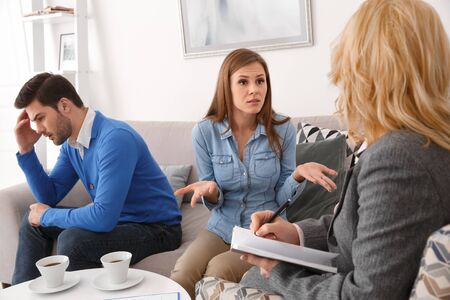 Young couple with psychologist family therapy girlfriend explaining problemの写真素材