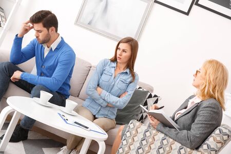 Young couple with psychologist family therapy husband disappointed by wifeの写真素材
