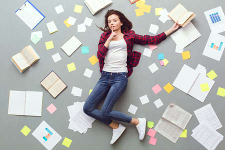 Young woman top view isolated on grey silence gestureの写真素材