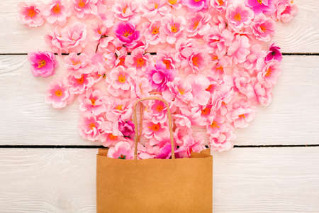 Pink flowers in a paper bag celebration objects applique top viewの写真素材