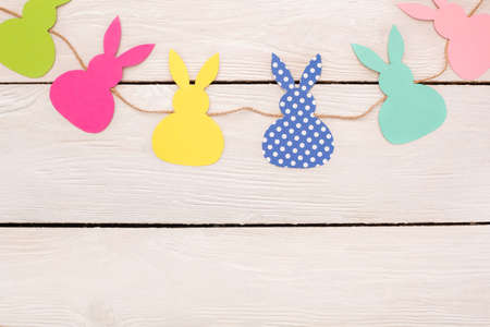 Easter traditional objects isolated on wooden floor paper rabbits decorations