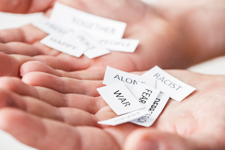 Man hands close-up holding papers with social problems negativeの写真素材