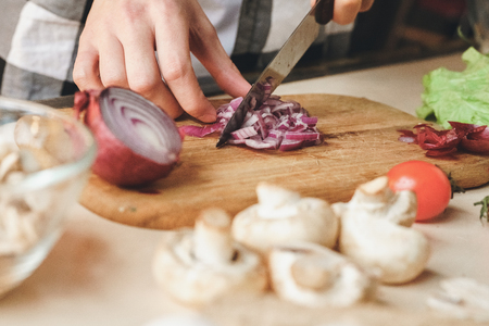 Shallow purpule onion and many other vegitables on cutting board. Indoor, studio shotの写真素材
