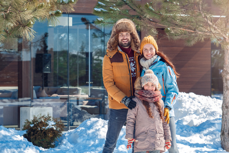 Winter vacation. Family time together outdoors hugging smiling cheerfulの写真素材