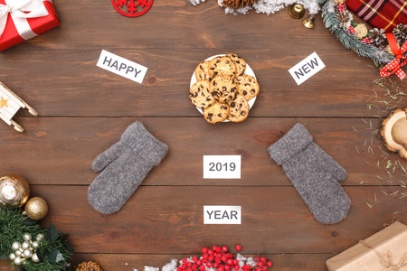 Happy New 2019 Year. Mittens and plate of cookies isolated on table top view close-upの写真素材