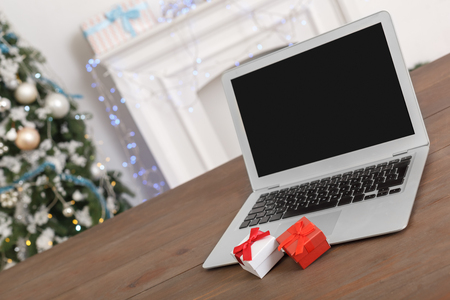 New Year. Decorated room no people laptop on table with gifts close-upの写真素材