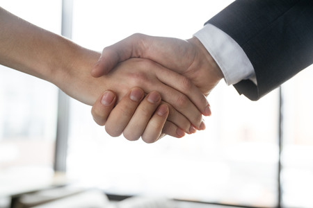 Businesspeople having business lunch at restaurant standing greeting close-upの写真素材