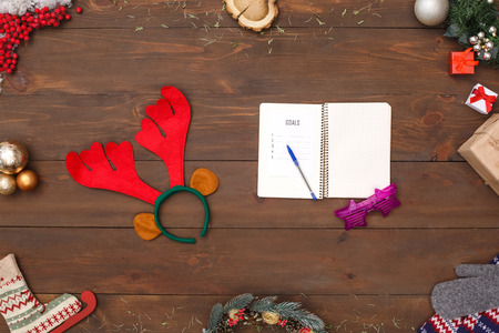 New Year Goals. Notebook fancy glasses and deer antlers isolated on table top view close-upの写真素材