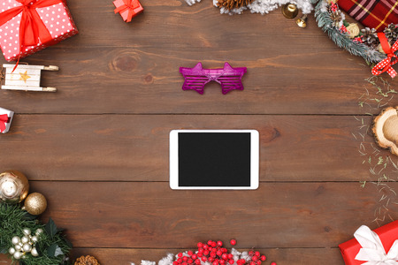 New Year. Digital tablet horixontal and eyeglasses isolated on table top view close-upの写真素材