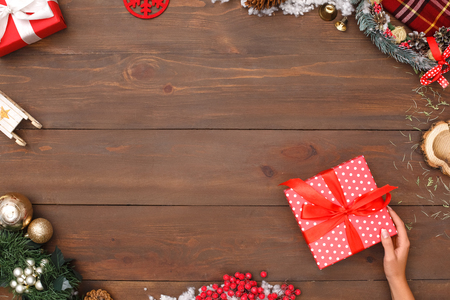 New Year. Woman putting gift on table top view close-upの写真素材