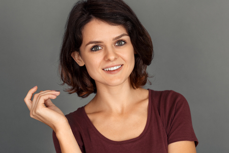 Freestyle. Young woman isolated on grey smiling excited face close-upの写真素材
