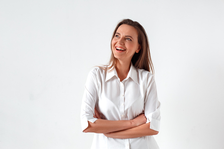 Freestyle. Woman standing isolated on white crossed arms laughing happy inspired with new ideaの写真素材