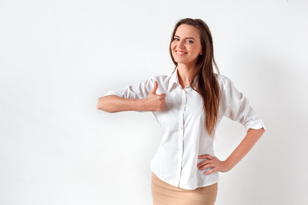 Freestyle. Woman standing isolated on white thumb up posing to camera cheerfulの写真素材