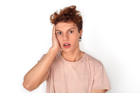 Teenager with earrings studio standing isolated on white touching head confusedの写真素材