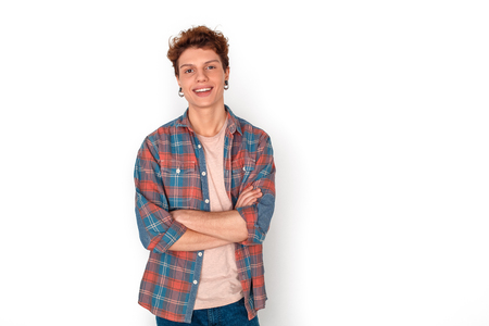 Teenager with earrings studio standing isolated on white crossed arms laughing cheerfulの写真素材