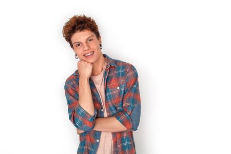 Teenager with earrings studio standing isolated on white leaning on hand looking camera dreamfulの写真素材