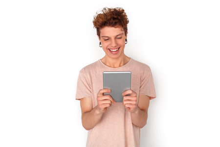 Teenager with earrings studio standing isolated on white video chat on digital tablet cheerfulの写真素材