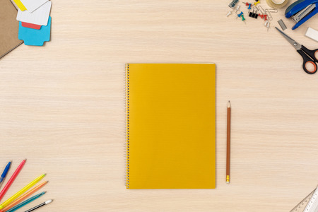 Wooden desk workplace top view nobody notebook and pencil planning day