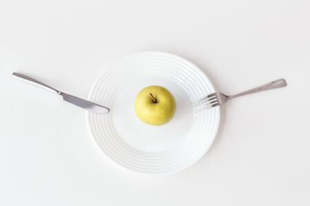 Be on Diet. Apple on plate isolated on kitchen table top view close-upの写真素材