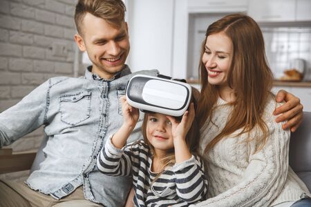 Family at home together leisure love concept take off virtual reality headsetの写真素材