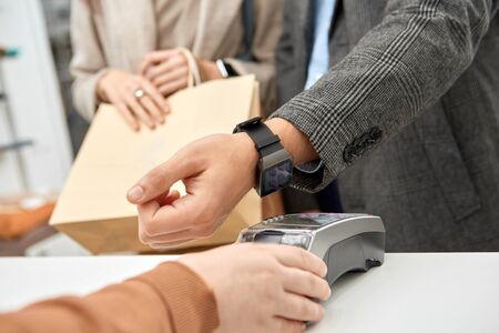 Adult man using smart watch, paying for stuff