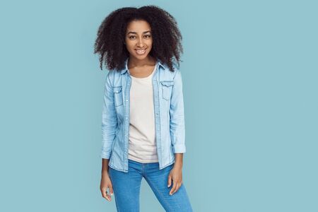 Freestyle. African girl standing isolated on gray posing smiling joyfulの写真素材