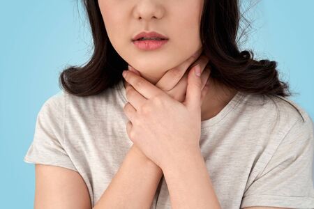Young adult asian girl with sore throat