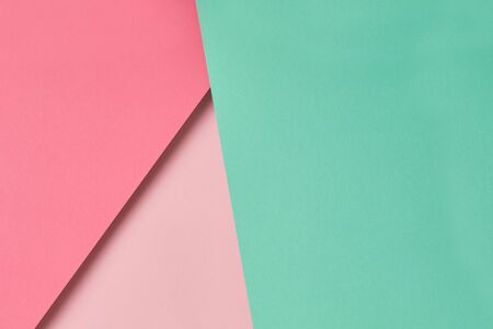 Colorful and pastel shades of pink and turquoise paper background with copy space. Blank for design, backdrop, concept of geometric compositionの写真素材