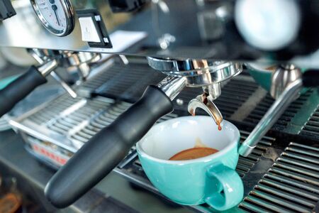 Close up view of professional coffee machine making fresh, aromatic espresso beverage in glass cupの写真素材