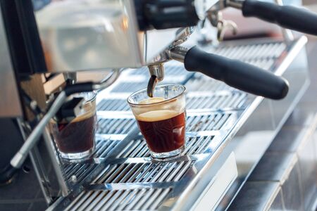 Espresso machine with shot glass close-up at coffee machineの写真素材