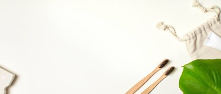Eco-friendly Concept. Two bamboo toothbrushes and toothpaste isolated on white top view copy spaceの写真素材