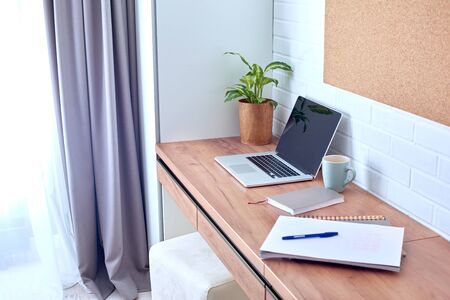 Laptop notebook and organizer isolated on wood desk workspace home officeの写真素材