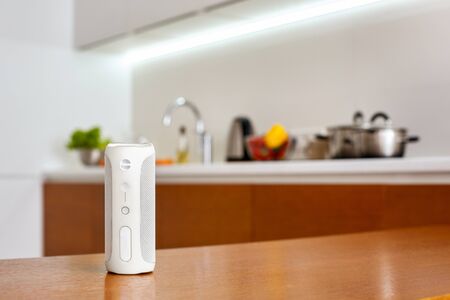Smart wireless speaker isolated on table at kitchen at home close-up blurred backgroundの写真素材