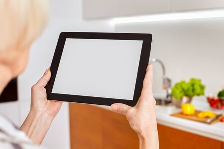 White screen monitor tablet, blank copy space place for text, space, mockup for icon home smart intellectual system. Network details lighting radiators appliances. Woman lady use smartphone to controlの写真素材