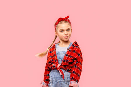 Freestyle. Little girl in bandana on head with braids standing isolated on pink posing smiling confidentの写真素材