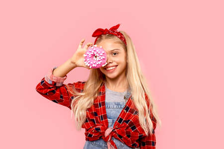 Little girl cover eye with sweet donutの写真素材