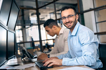 Businessman checking global currency index on fund exchange sitting in officeの写真素材