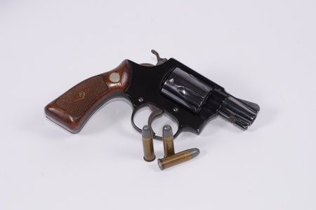 Hand gun in white back ground  Gun is for self-defense  It is dangerous for the young guy  Keep it away from children の写真素材