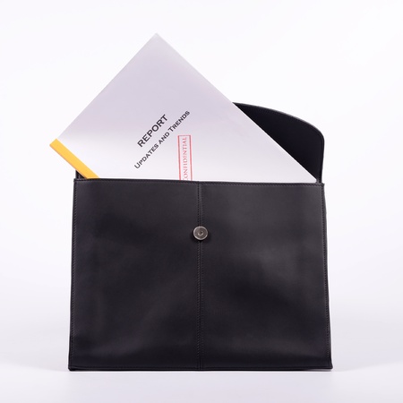 Confidential report in black brieftcase on white background の写真素材